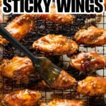 asian sticky wings on wire rack being brushed with sauce