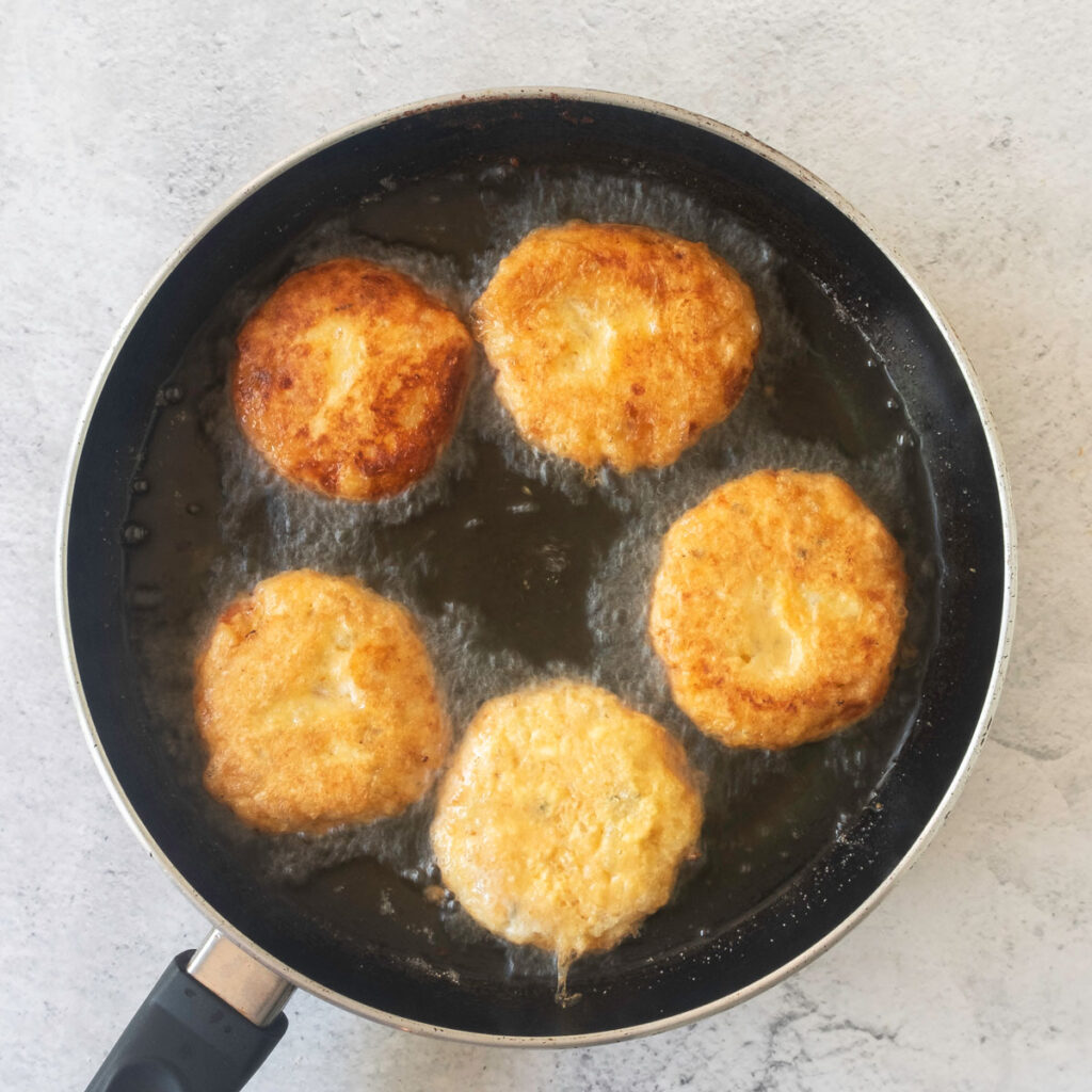 potato fritters frying in pan