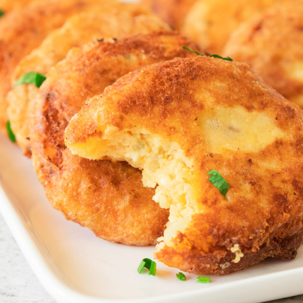 potato fritters with one having a bite taken out