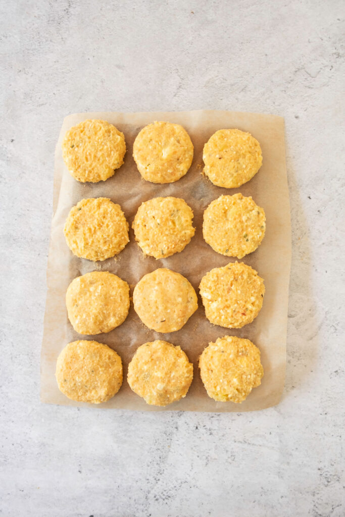potato fritters before frying on parchment paper