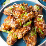asian sticky wings on blue plate