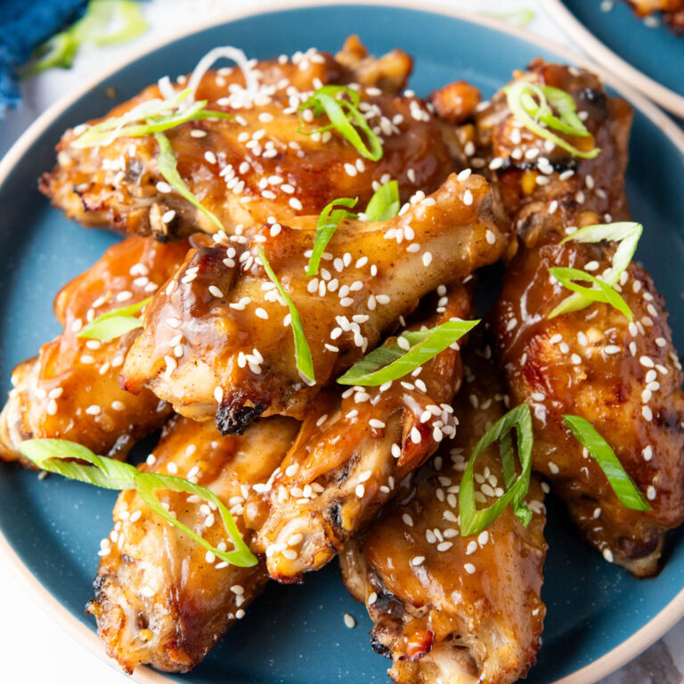 asian sticky wings on blue plate