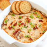 crack chicken dip with crackers on top