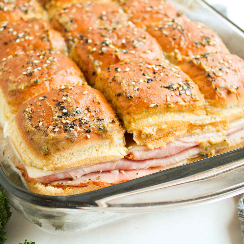 ham and swiss sliders in glass baking dish