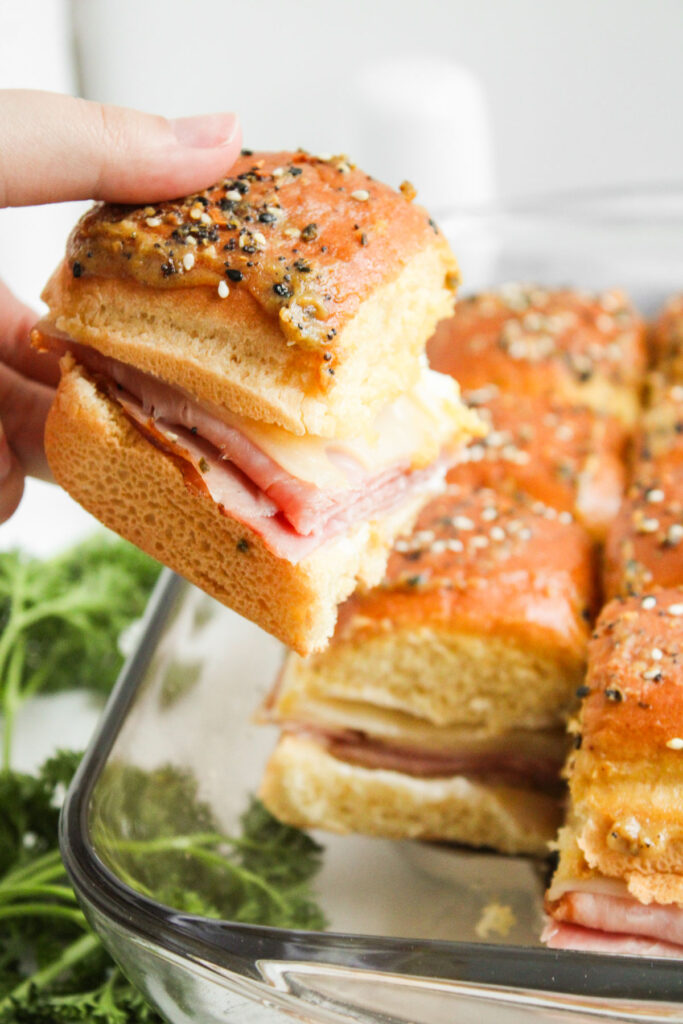 hand holding ham and swiss slider