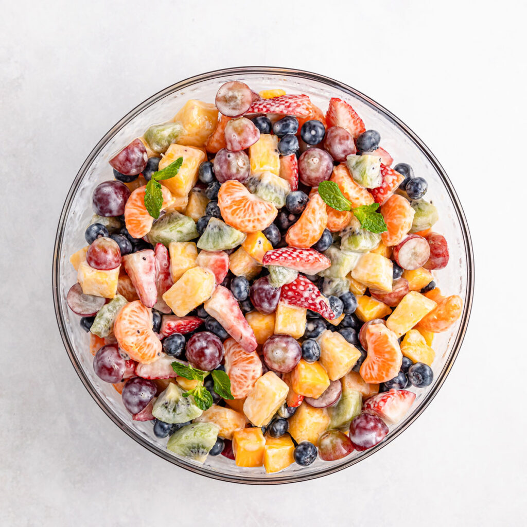 fruit salad with yogurt dressing in glass bowl