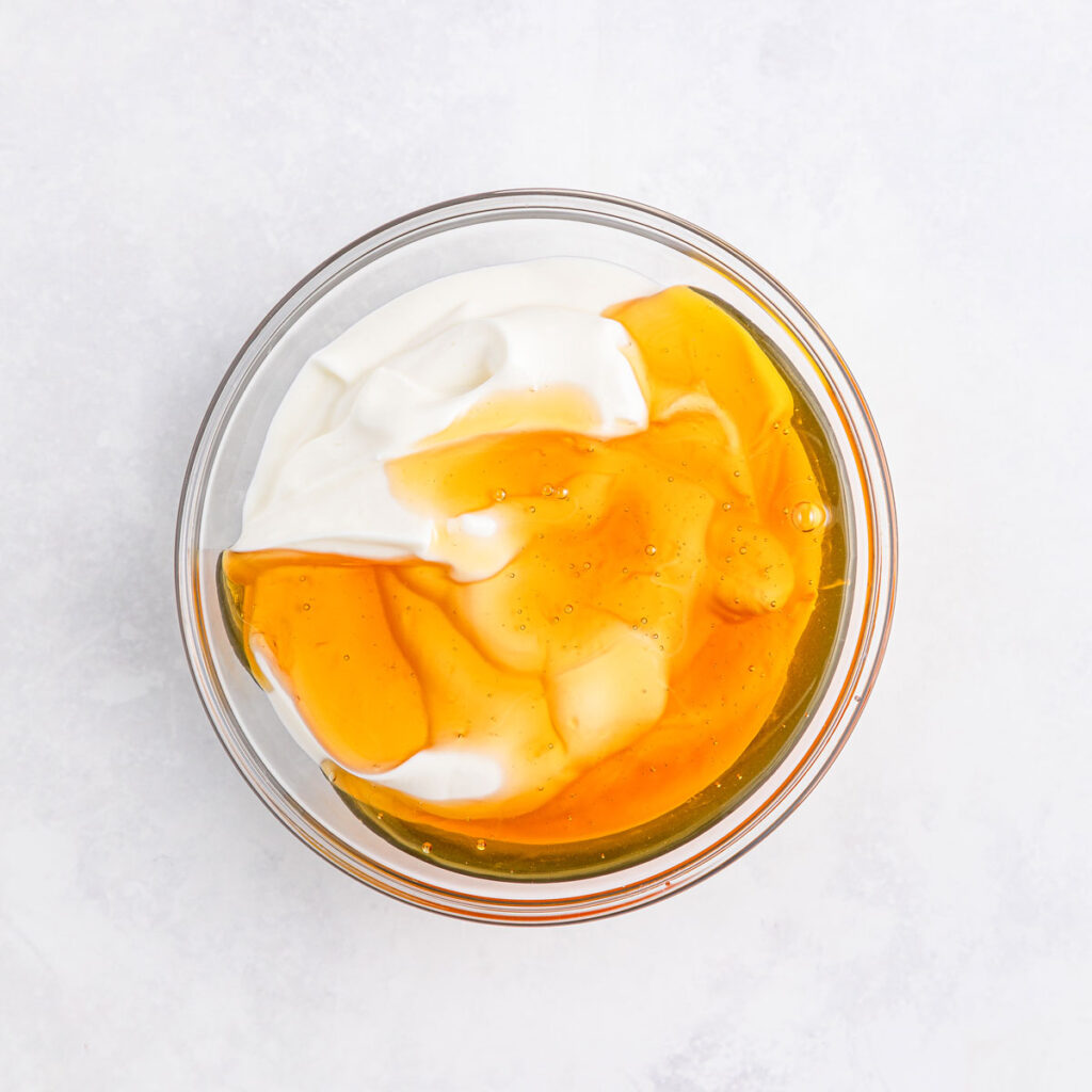 yogurt and honey in bowl to make fruit salad dressing