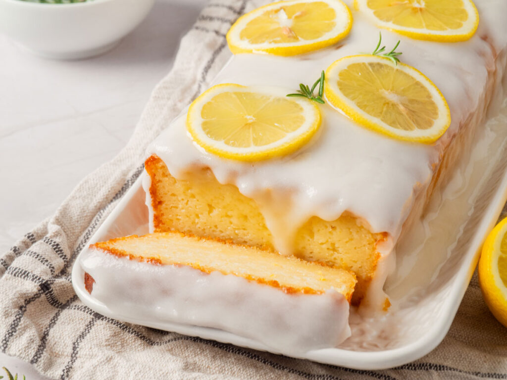 lemon loaf cake with one slice removed