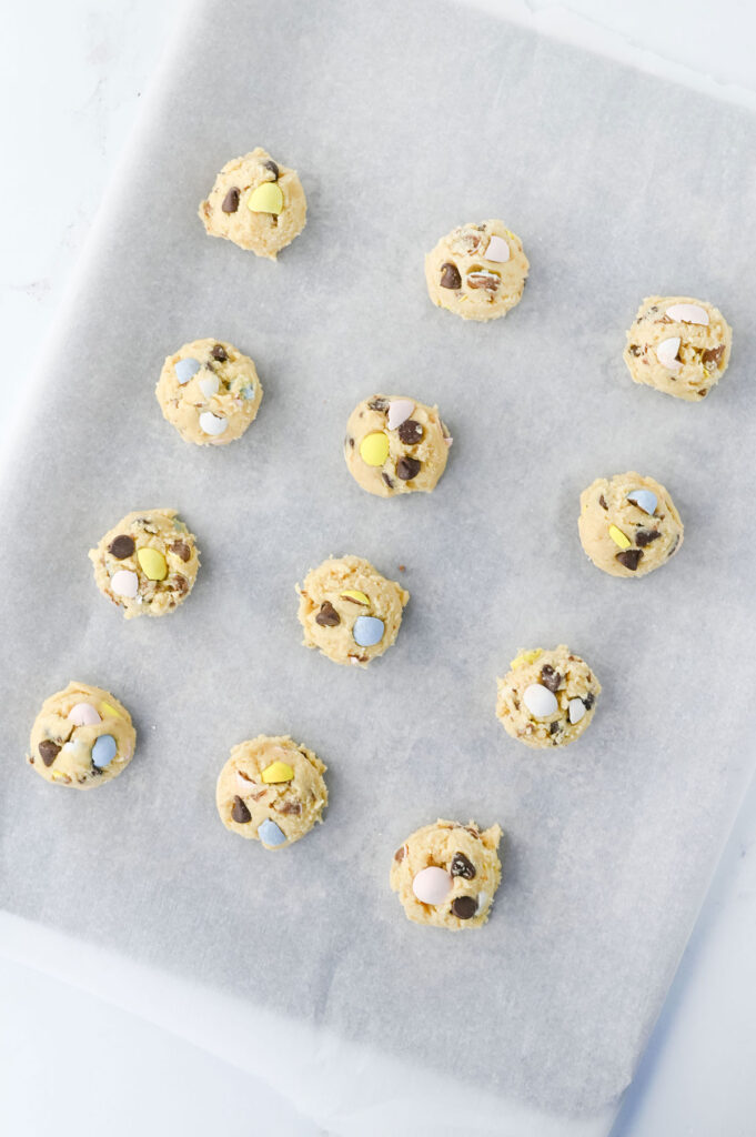 cadbury egg cookies dough balls before cooking on baking sheet