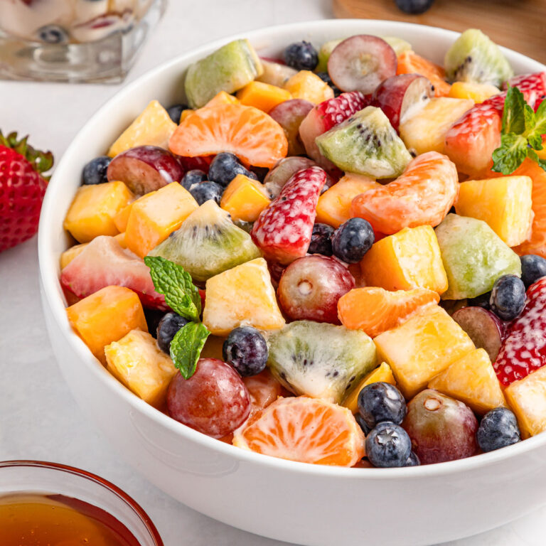 creamy fruit salad in white bowl