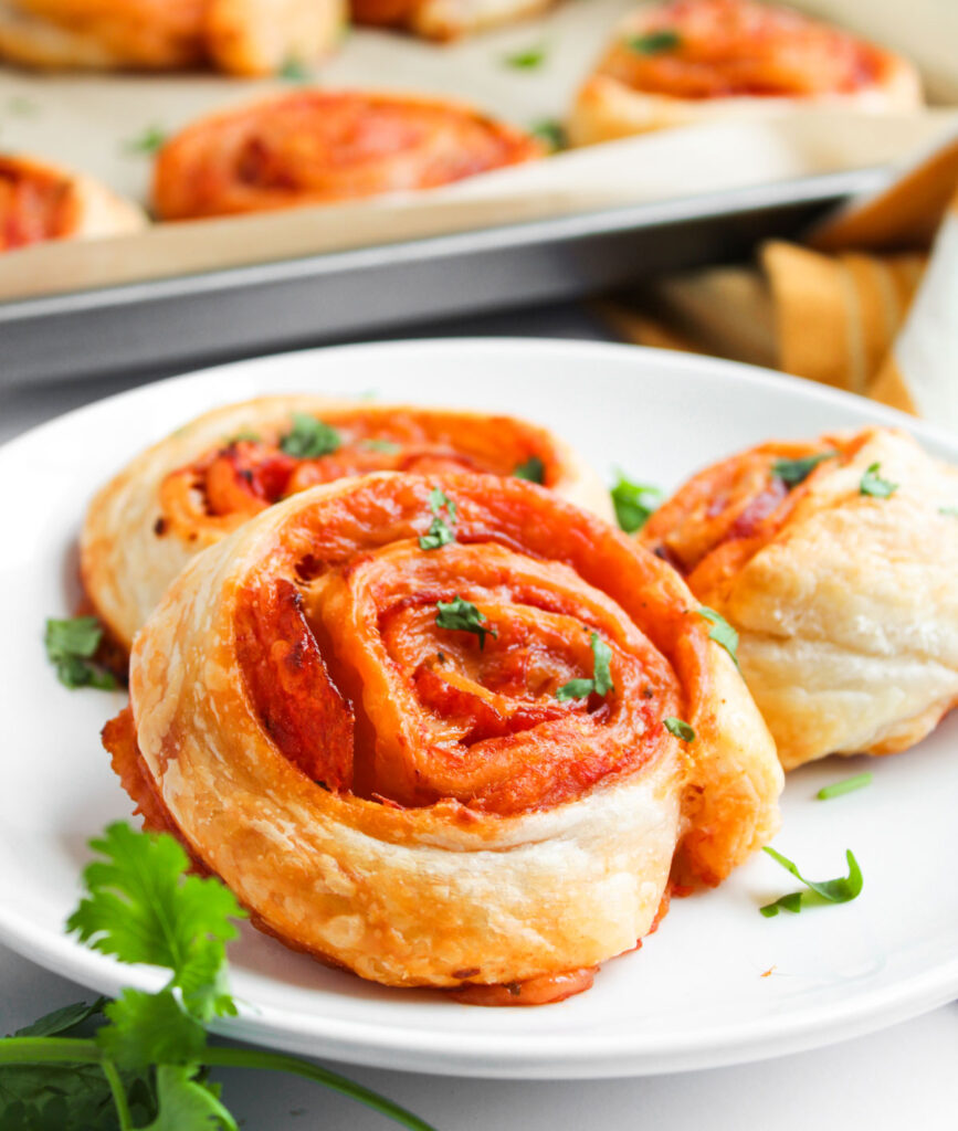 pizza pinwheels on white plate