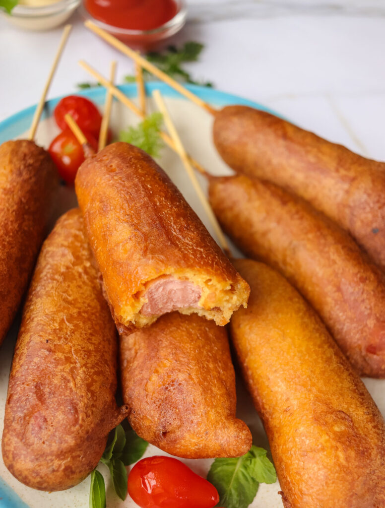 homemade corndogs with one having bite removed