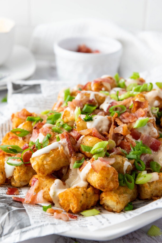 loaded tater tots on paper lined platter