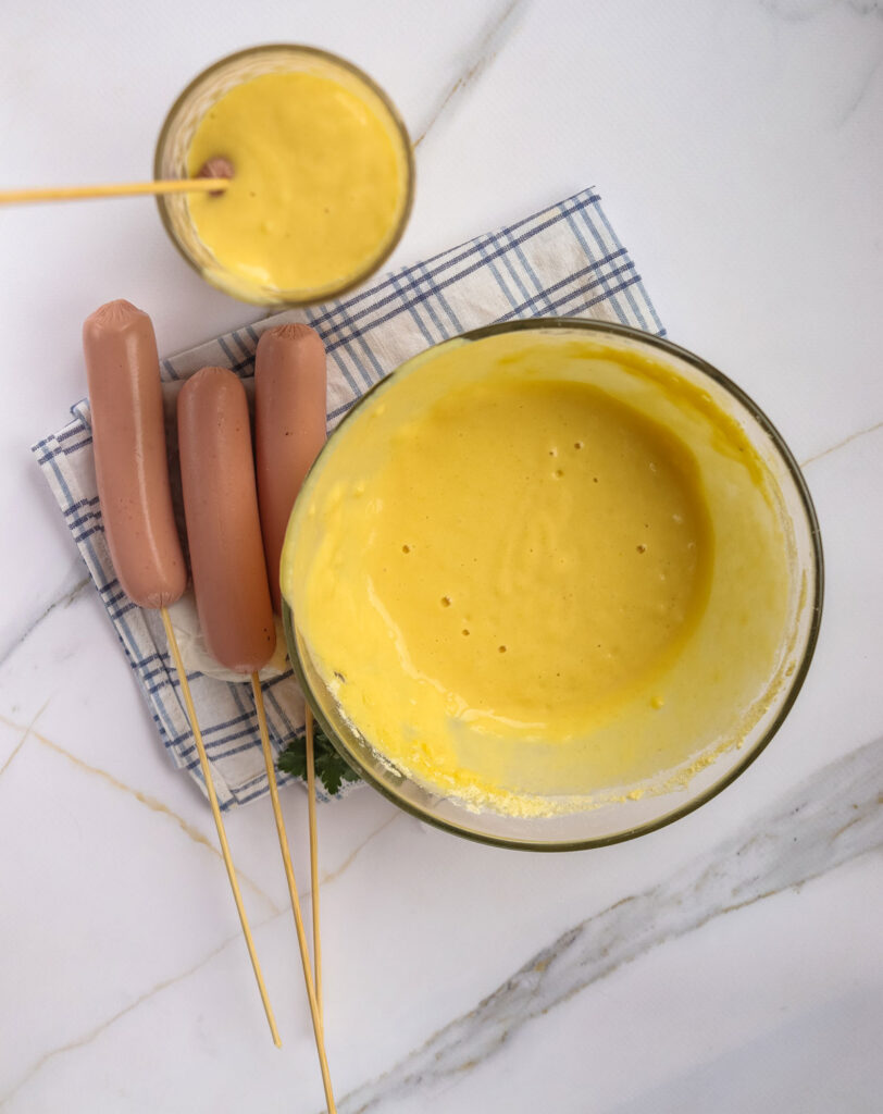 hot dogs on sticks with corndog batter