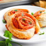 pizza pinwheels on white plate