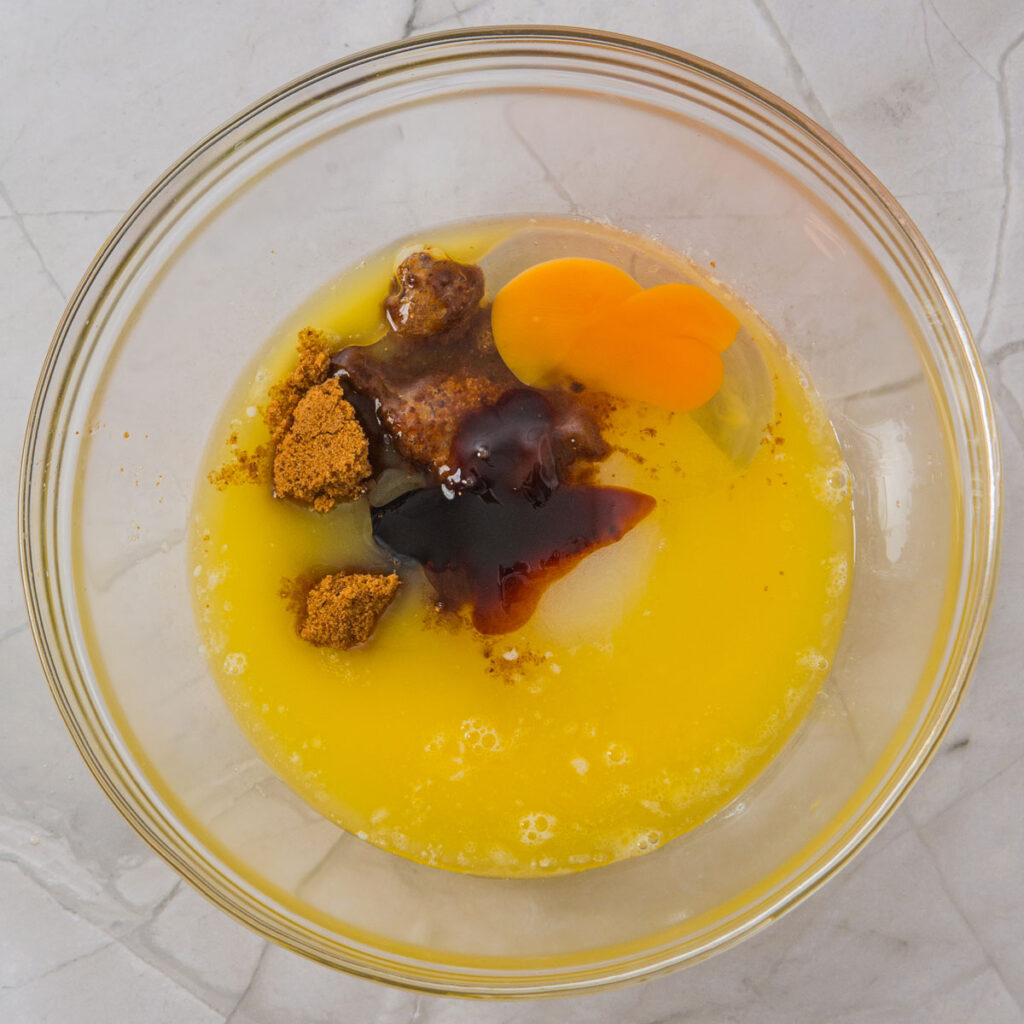 egg, butter, and brown sugar in glass bowl