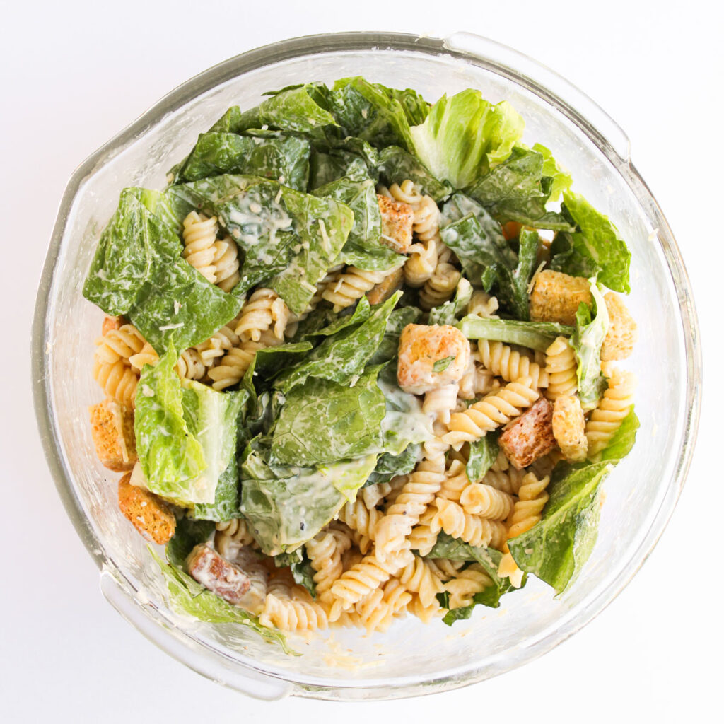 chicken caesar pasta salad in glass bowl