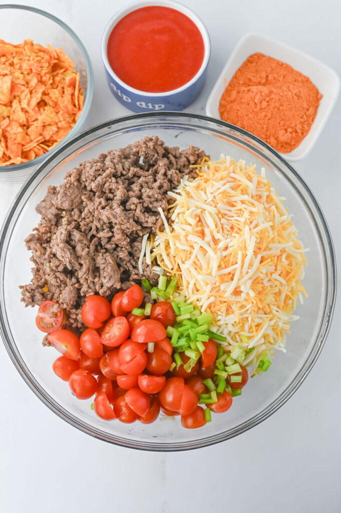 taco pasta salad ingredients in glass bowl