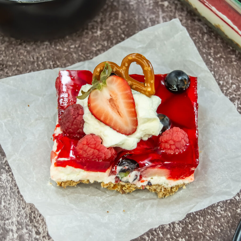 slice of pretzel berry salad on parchment paper