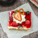 slice of pretzel berry salad on parchment paper