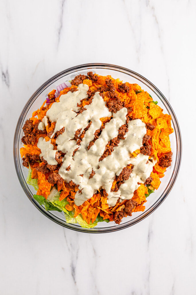 Doritos taco salad with dressing on top