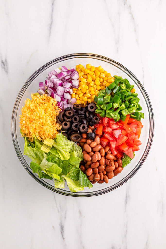mixing ingredients for Doritos taco salad