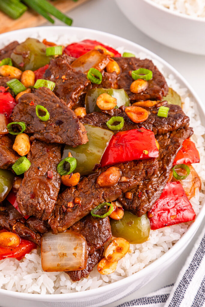 close up of kung pao beef over rice