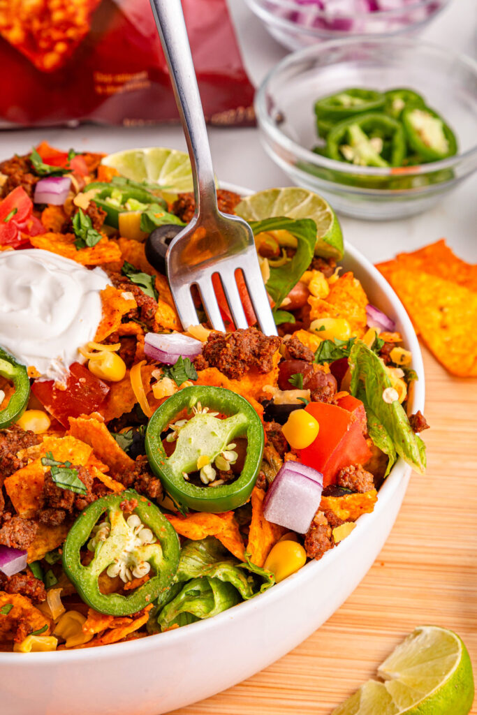 fork in bowl of Doritos taco salad