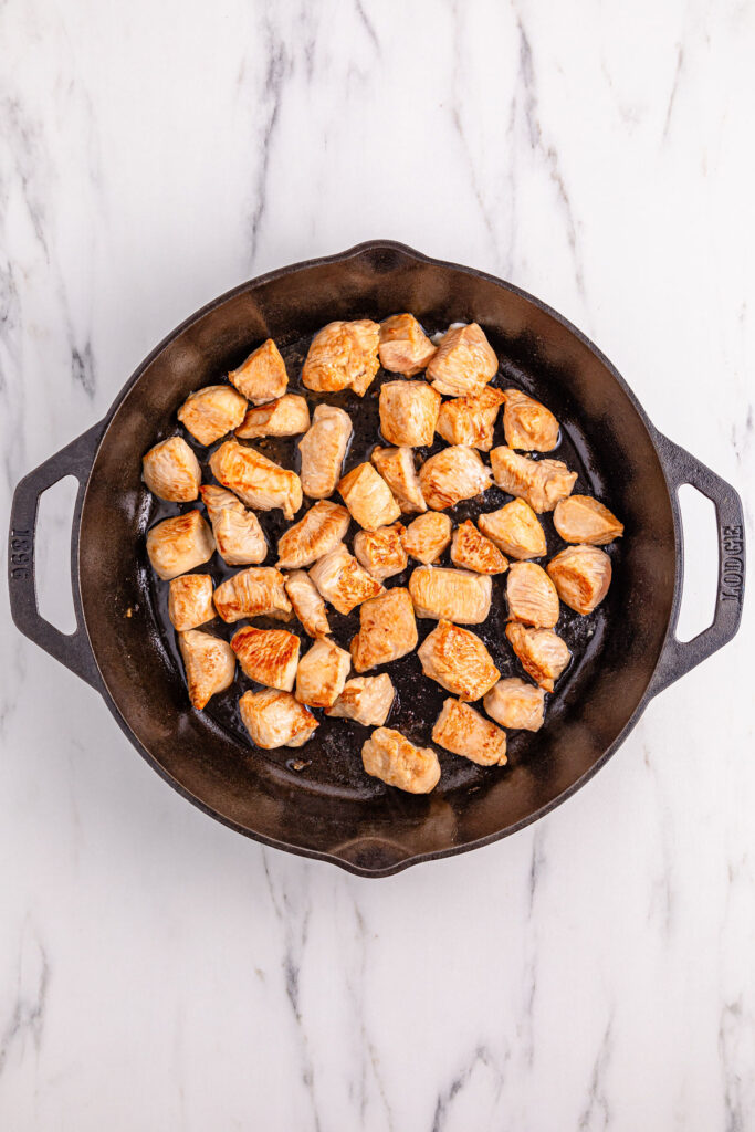 browning chicken in skillet for kung pao chicken