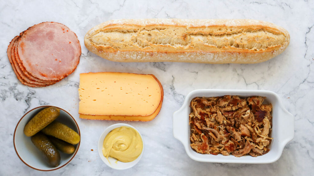 Cuban sandwich ingredients on marble countertop