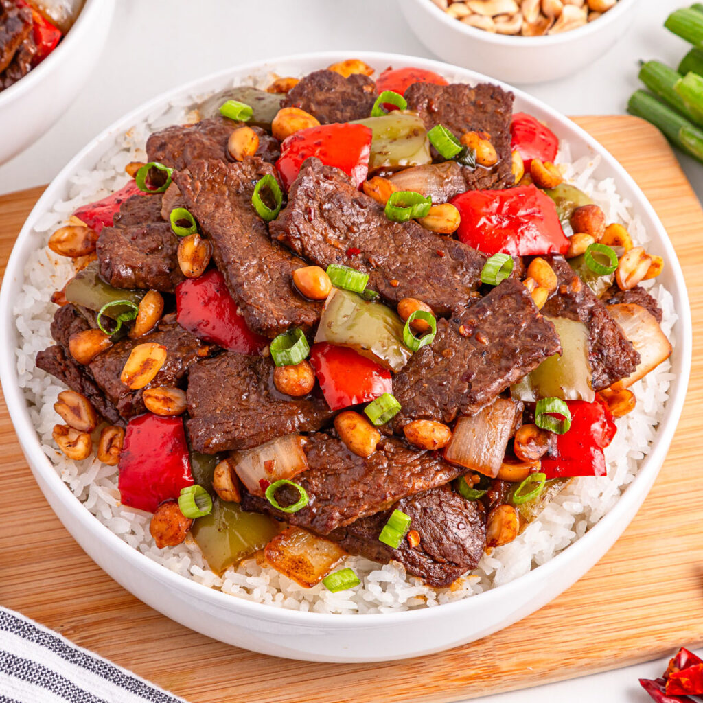 kung pao beef over rice in white bowl