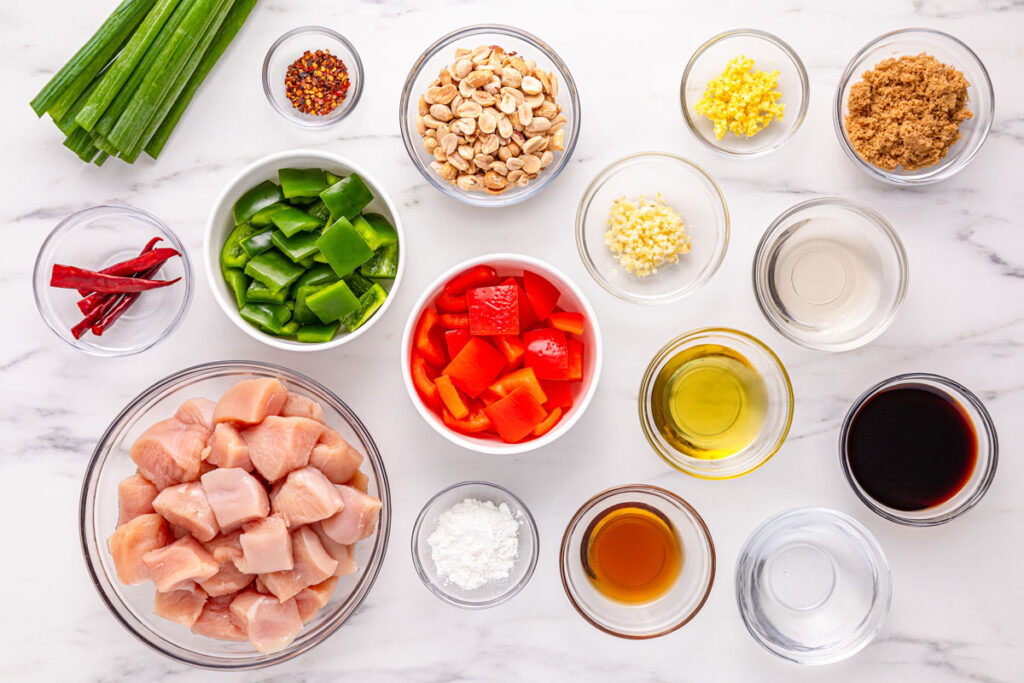 kung pao chicken ingredients in glass bowls on countertop