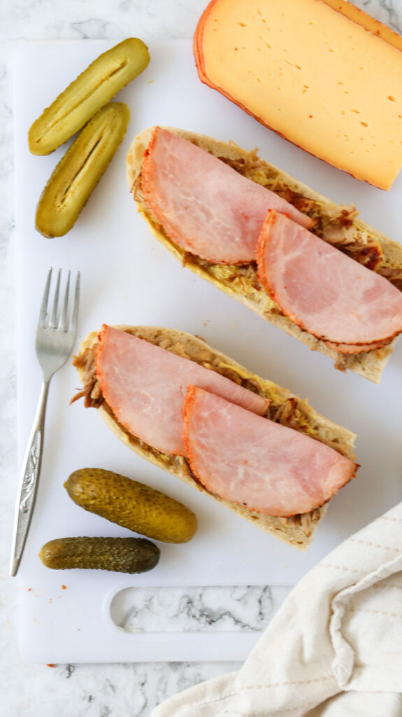 layering meat on Cuban sandwich