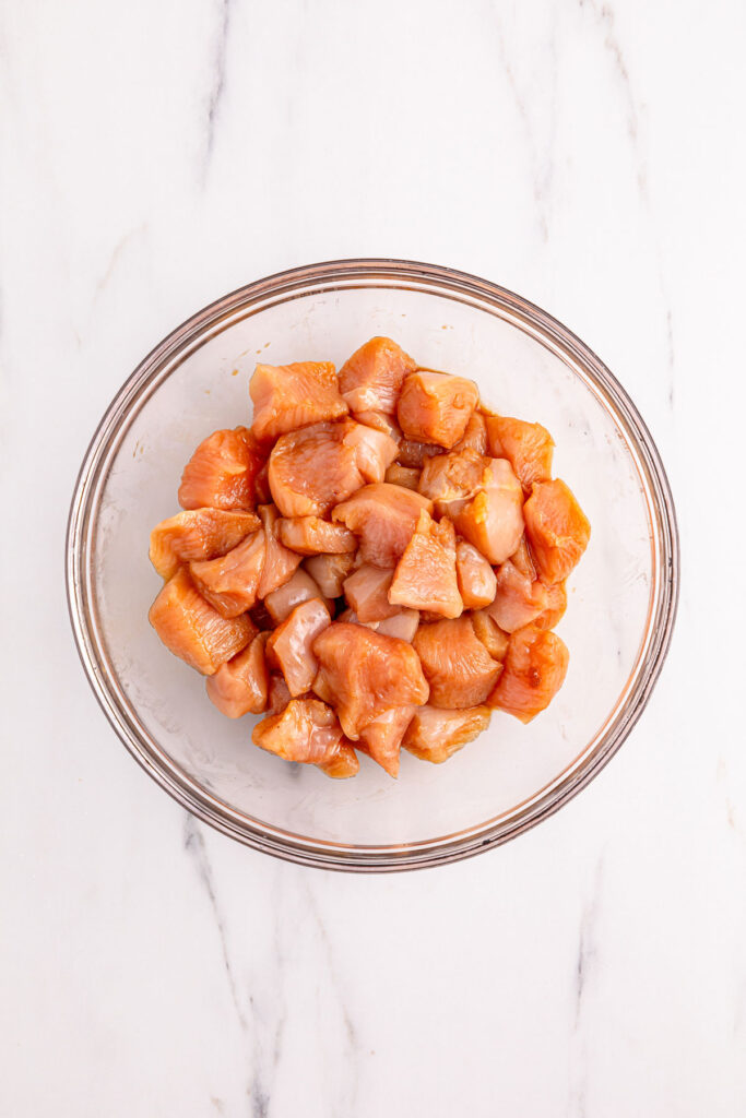diced chicken breast marinating for kung pao chicken
