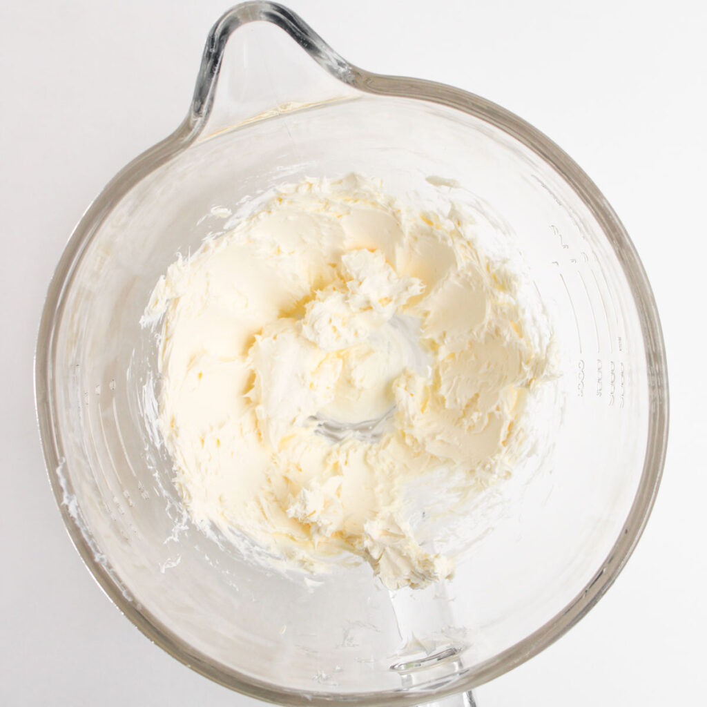 cream cheese in glass mixing bowl