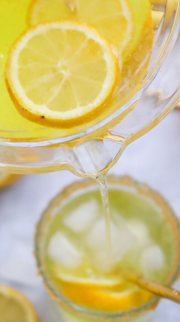pouring lemonade into glass