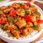 kung pao chicken on rice in white bowl
