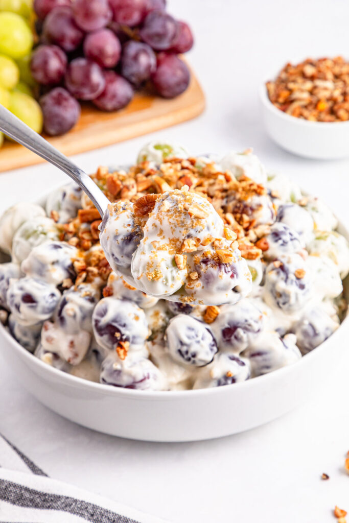 spoonful of grape salad help over bowl of grape salad