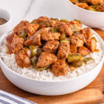 bowl of black pepper chicken over rice
