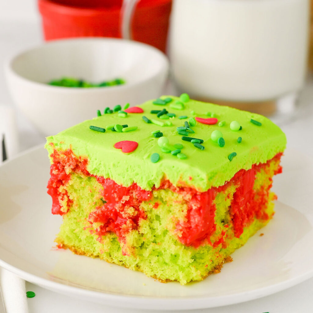 piece of grinch poke cake on white plate