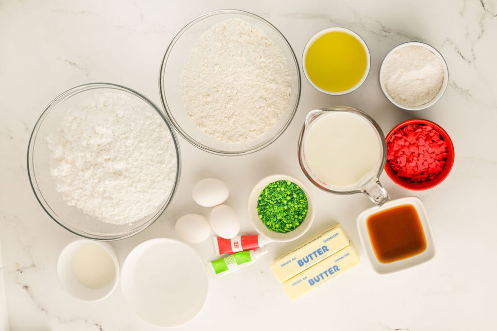 grinch poke cake ingredients in bowls on countertop