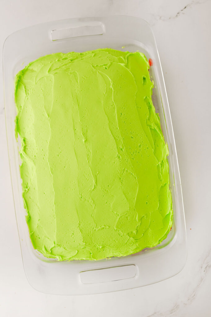 green frosted grinch poke cake