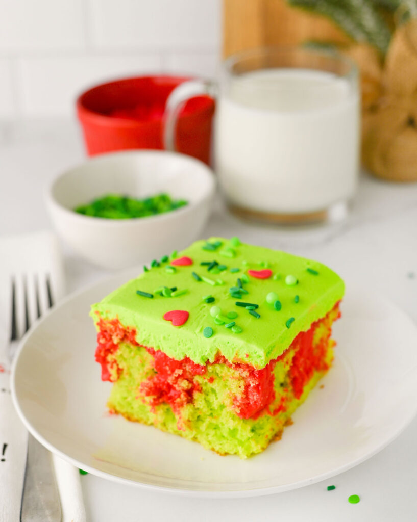 piece of grinch poke cake on white plate
