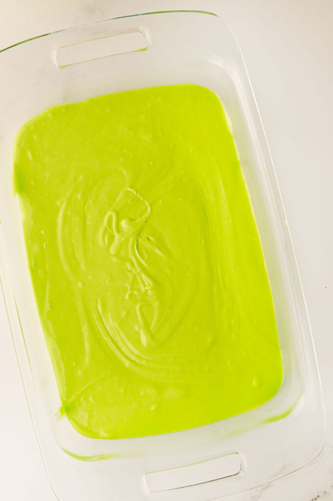 green cake mix in pan before baking