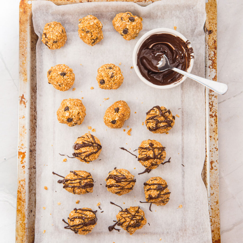 drizzling peanut butter oatmeal balls with melted chocolate