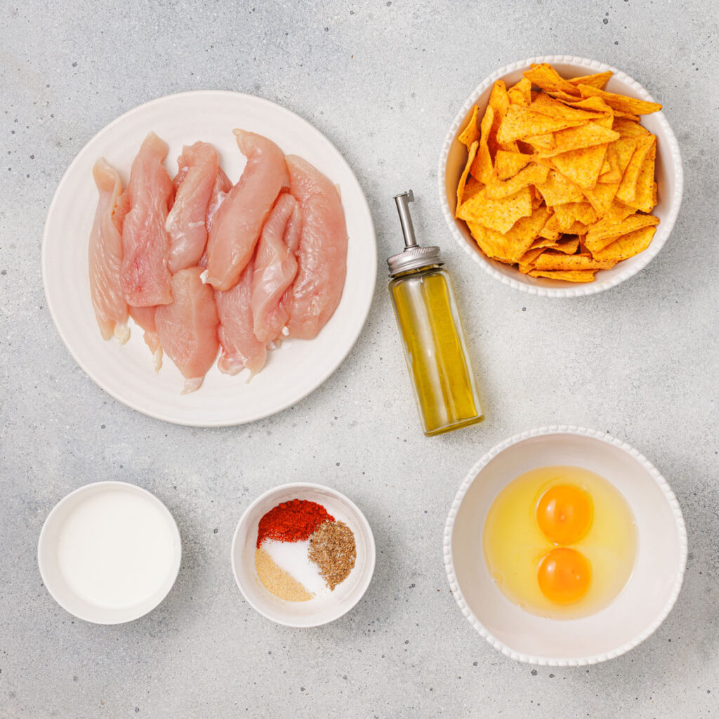 Doritos chicken tenders ingredients in bowls on countertop