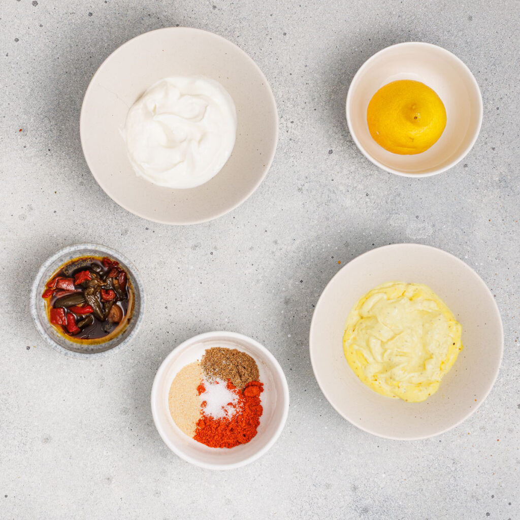 chipotle ranch dressing ingredients in bowls on countertop