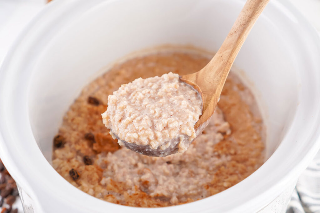 scooping slow cooker rice pudding