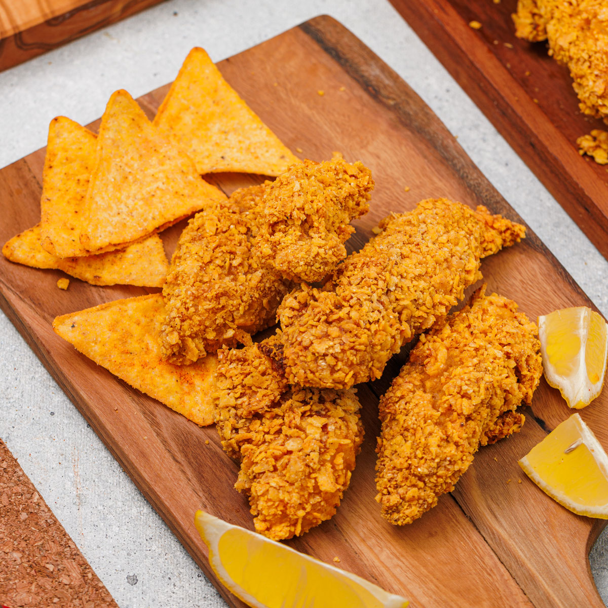 Doritos chicken tenders and doritos on cutting board