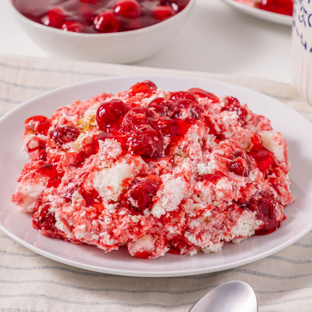 white plate full of cherries in the snow